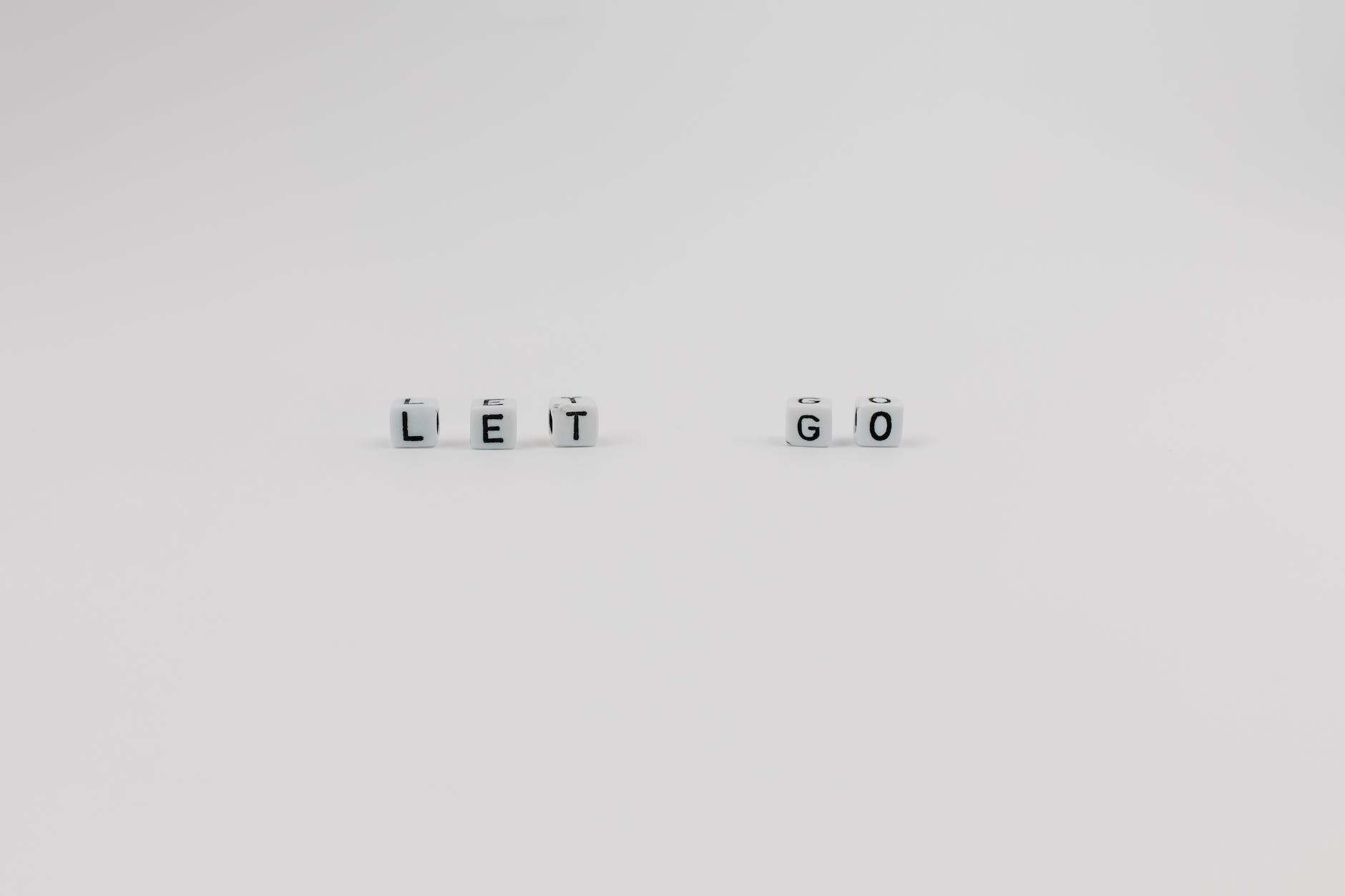 a let go slogan spelled with letter dice on white background