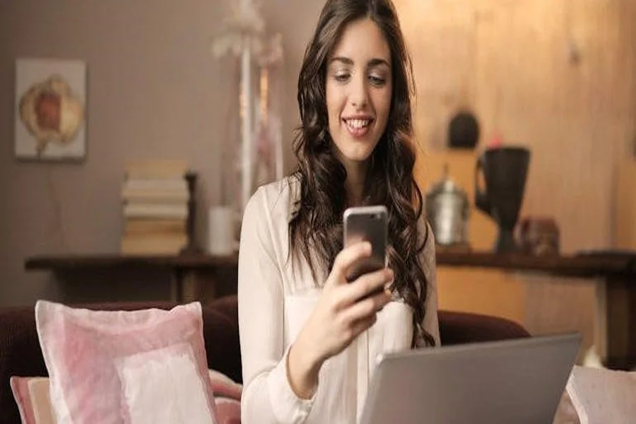a woman using her laptop and smartphone